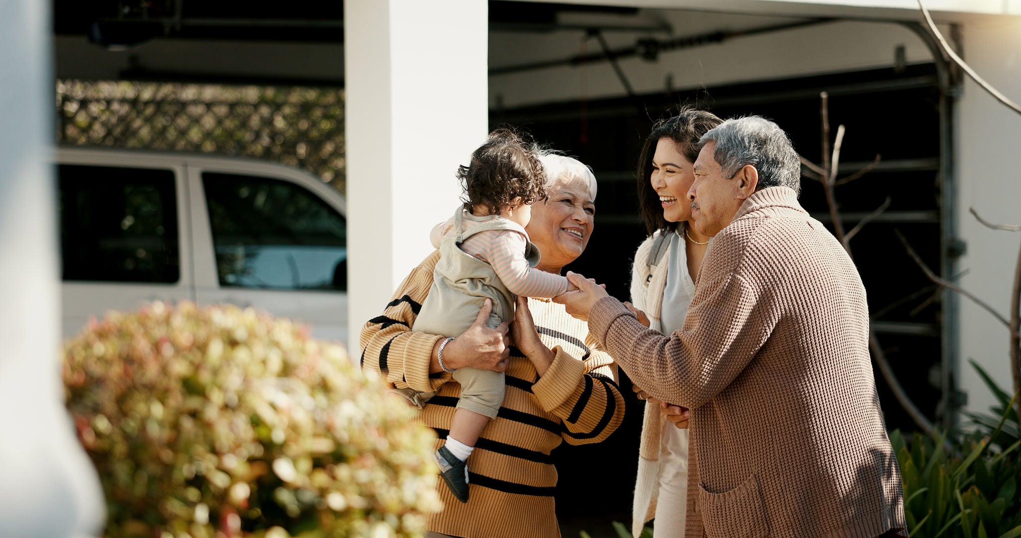 Family, welcome and hug outdoor of home in backyard with mother, grandparents and child with love and care. Reunion, woman and kid visit parents, travel and surprise for holiday with embrace or joy